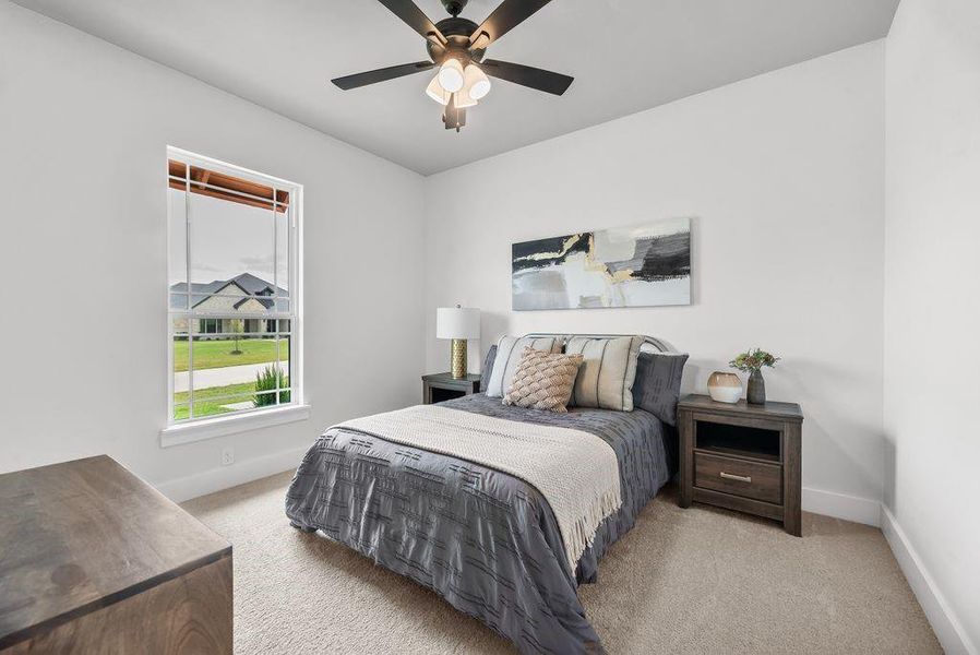 Bedroom featuring carpet floors and a ceiling fan Bedroom featuring carpet floors and a ceiling fan