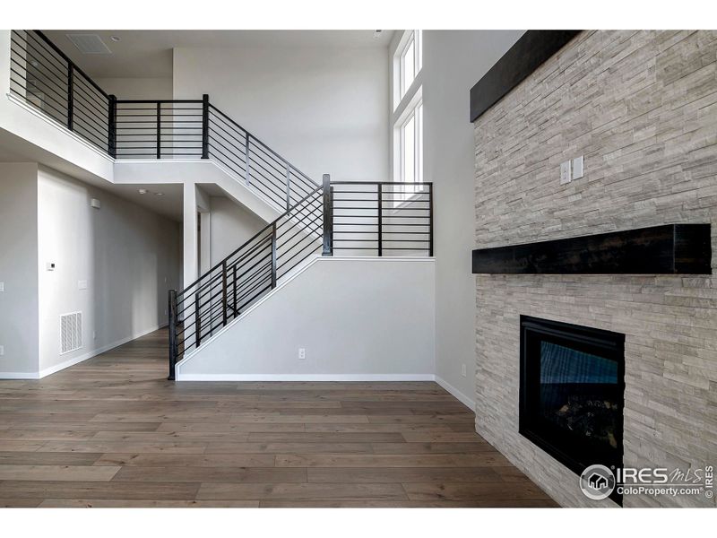 The living room is very large with oversized windows