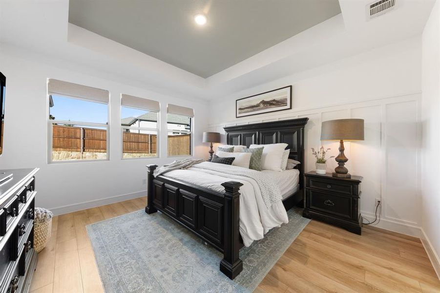 Spacious primary suite with natural light and private access to the luxurious en-suite bathroom.