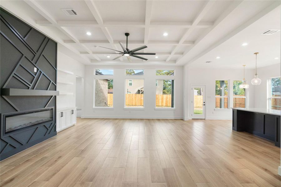 Bright and expansive living area featuring an electric fireplace.