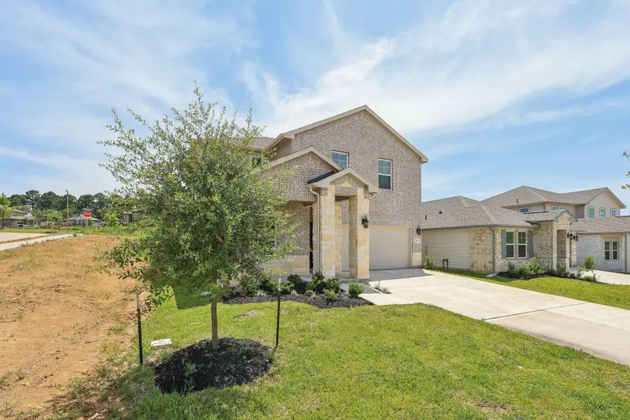 Front exterior of a new home in Pine Lake Cove - Premier Series, Montgomery, TX, highlighting curb appeal (Image 4). Front exterior of a new home in Pine Lake Cove - Premier Series, Montgomery, TX, highlighting curb appeal (Image 4).