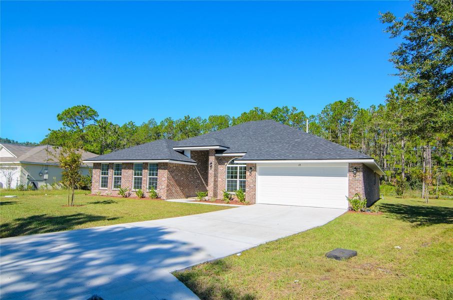 Front exterior of a new home in Palm Coast, Palm Coast, FL, highlighting curb appeal (Image 21).