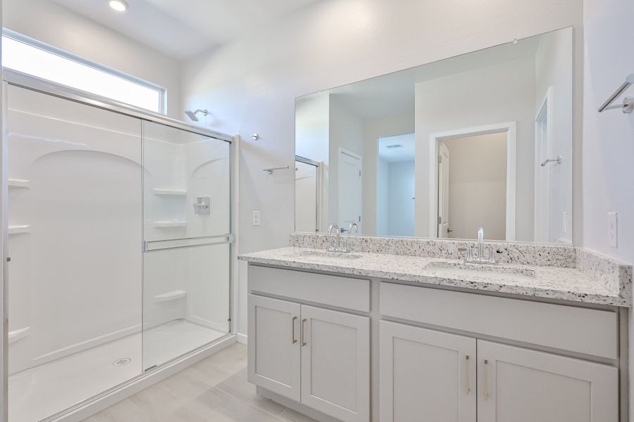 A bathroom with a large mirror. A bathroom with a large mirror.