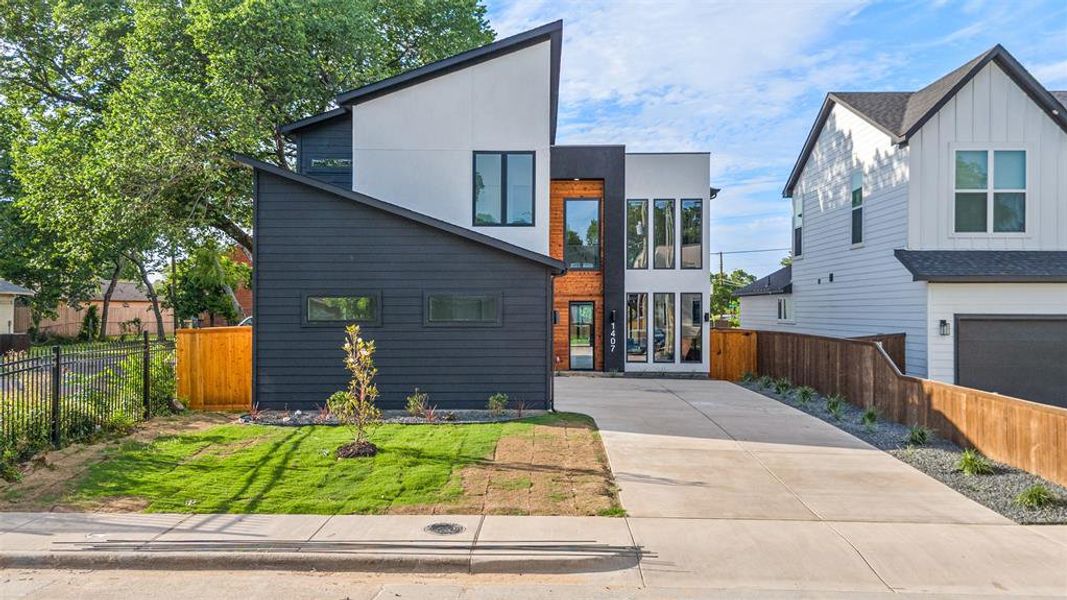 Modern exterior featuring a striking black and white facade with an angular roofline