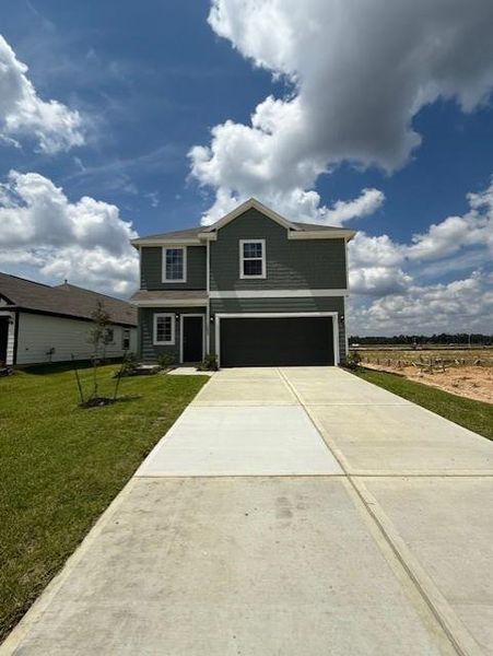Front exterior of a new home in Townsend Reserve, Splendora, TX, highlighting curb appeal (Image 2).