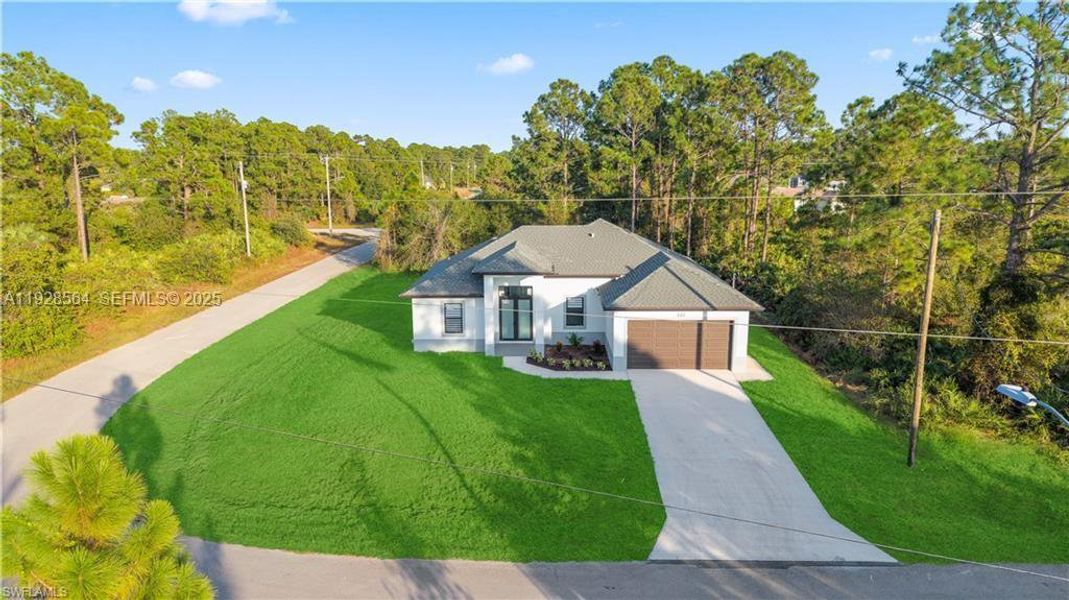 Front exterior of a new home in , Lehigh Acres, FL, highlighting curb appeal (Image 24).