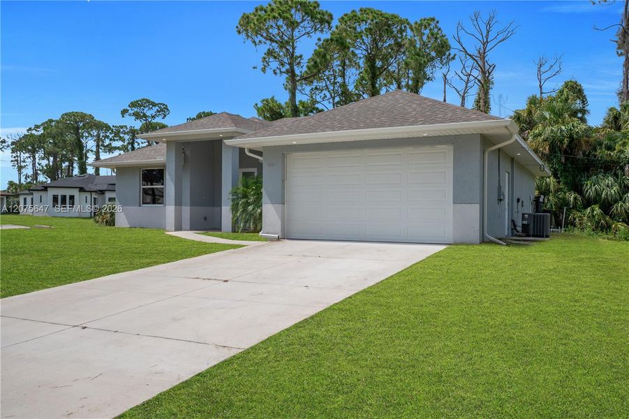 Front exterior of a new home in , Lehigh Acres, FL, highlighting curb appeal (Image 18).