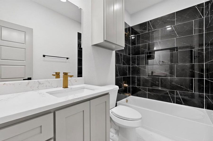 Bathroom with vanity and bathtub / shower combination