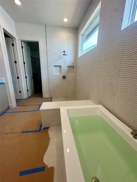 Full bathroom featuring a walk in shower, vanity, a walk in closet, and recessed lighting
