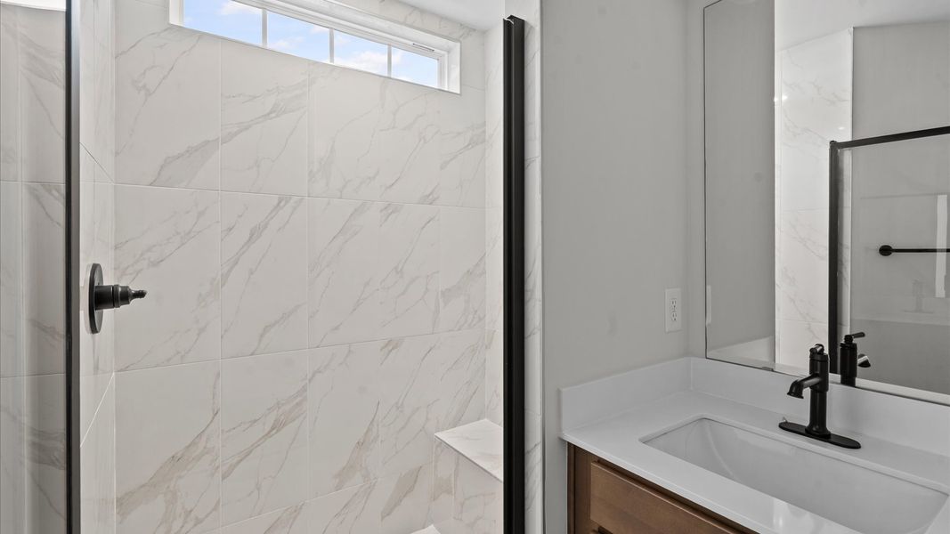 Highly functional and elegant en-suite with dual vanities, tiled walk-in shower, and refined finishes Highly functional and elegant en-suite with dual vanities, tiled walk-in shower, and refined finishes