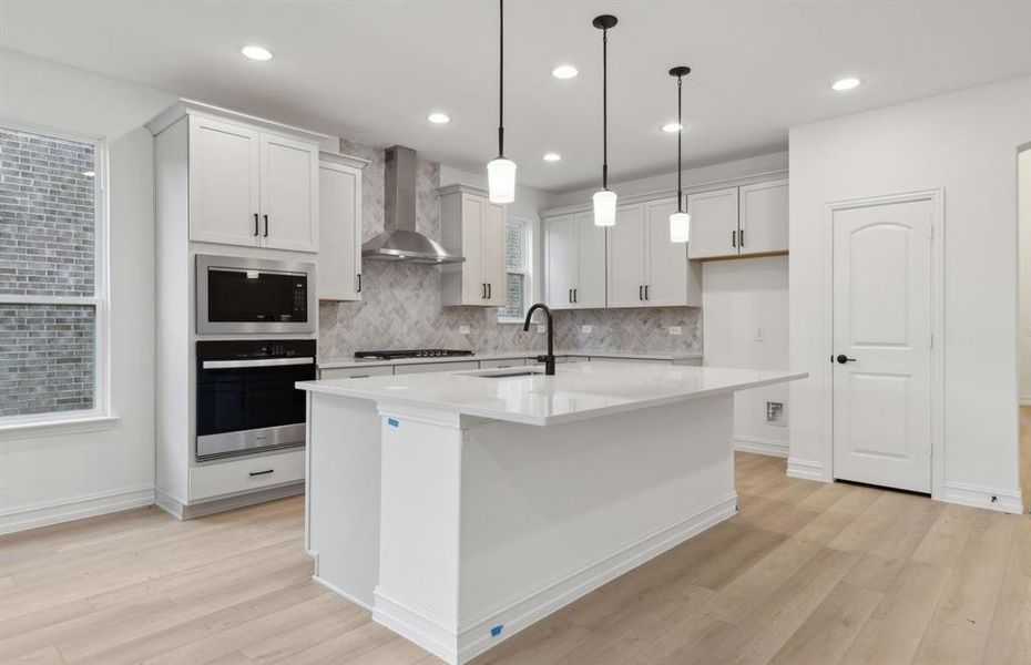 Bright kitchen with oversized island *real home pictured