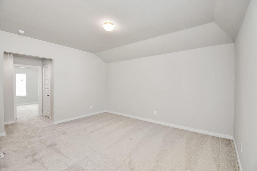 Come upstairs and relish a day of relaxation in this loft area! Ideal as an additional living space or game room, it boasts plush carpeting, high ceilings, custom paint, and windows that flood the area with abundant natural light. Sample photo of completed home with similar floor plan. Actual colors and selections may vary.