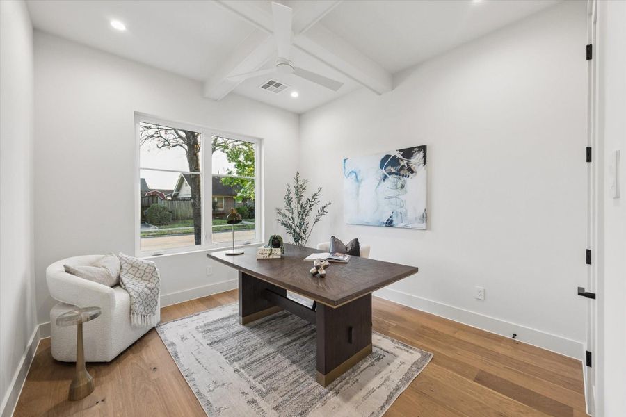 The first-floor 4th bedroom with full bath offers flexible space for a home office or guest suite. It features a coffered ceiling, recessed lighting, and a walk-in closet.