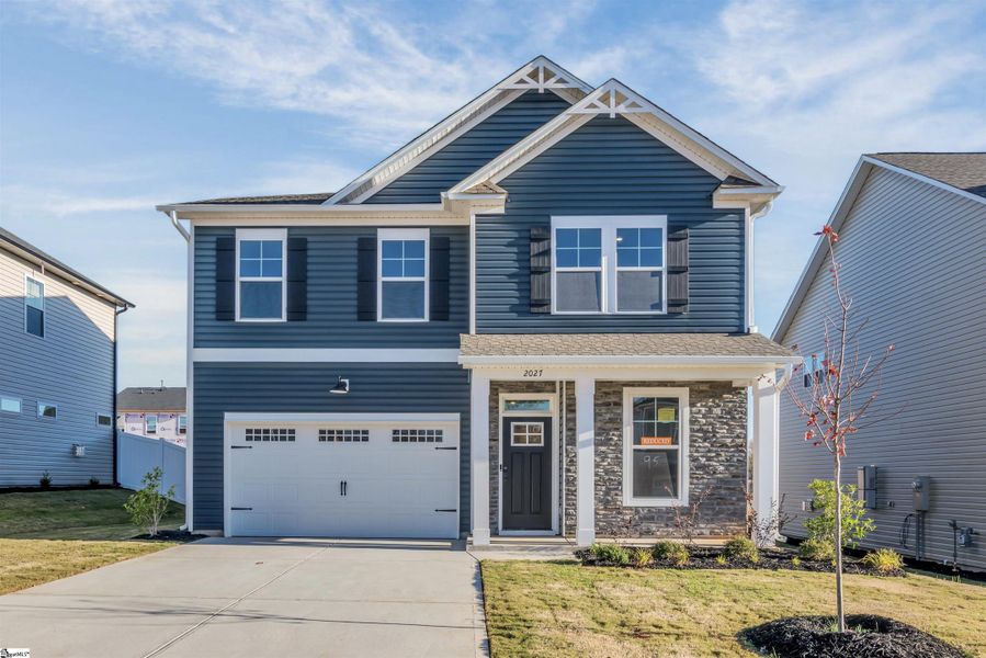 Front exterior of a new home in Halton Oaks, Spartanburg, SC, highlighting curb appeal (Image 2).