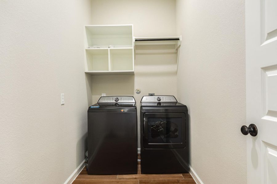 laundry area with clothes rack and storage laundry area with clothes rack and storage