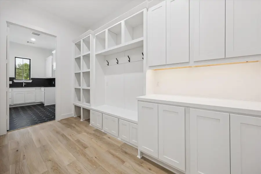 A well-appointed mudroom offers built-in cubbies, coat hooks, and abundant cabinetry to keep daily essentials organized and out of sight. A well-appointed mudroom offers built-in cubbies, coat hooks, and abundant cabinetry to keep daily essentials organized and out of sight.