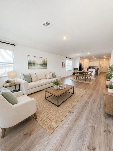 Natural light illuminates this spacious open-concept living area, perfect for daily life and entertaining.