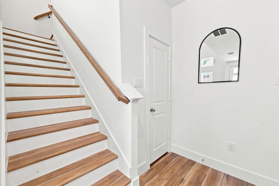 Beautiful wood staircase with coordinating handrail, adding warmth and character to the home’s clean, modern interior. Beautiful wood staircase with coordinating handrail, adding warmth and character to the home’s clean, modern interior.