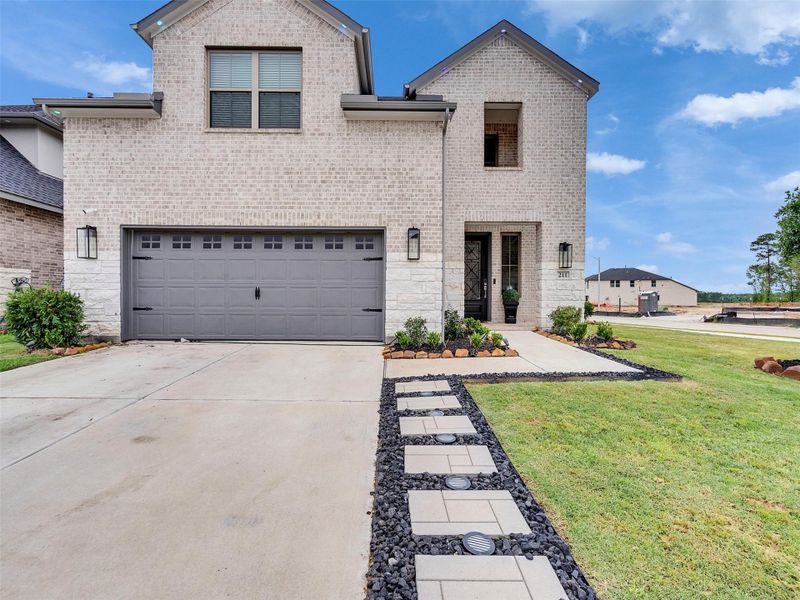 Front exterior of a new home in The Trails, New Caney, TX, highlighting curb appeal (Image 25). Front exterior of a new home in The Trails, New Caney, TX, highlighting curb appeal (Image 25).
