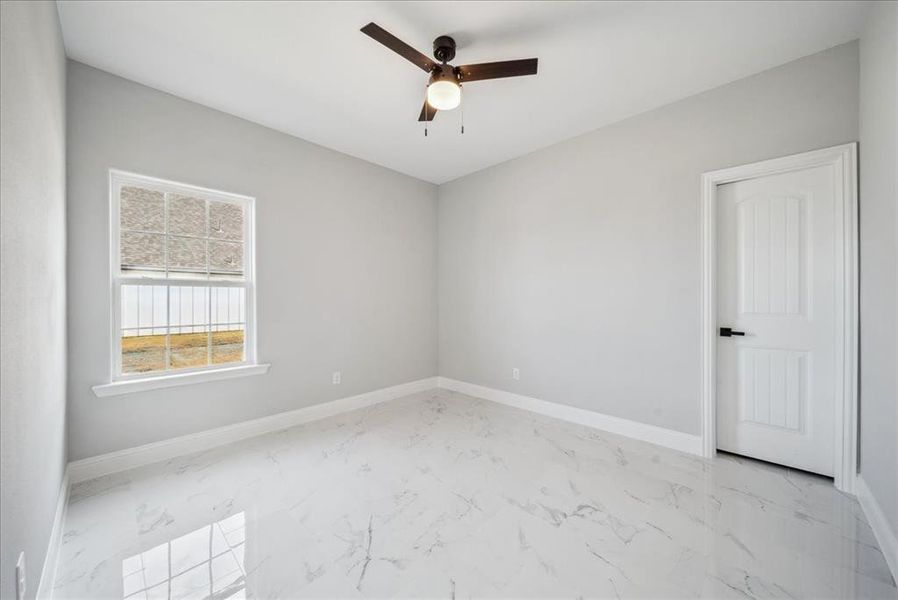 Spare room with ceiling fan