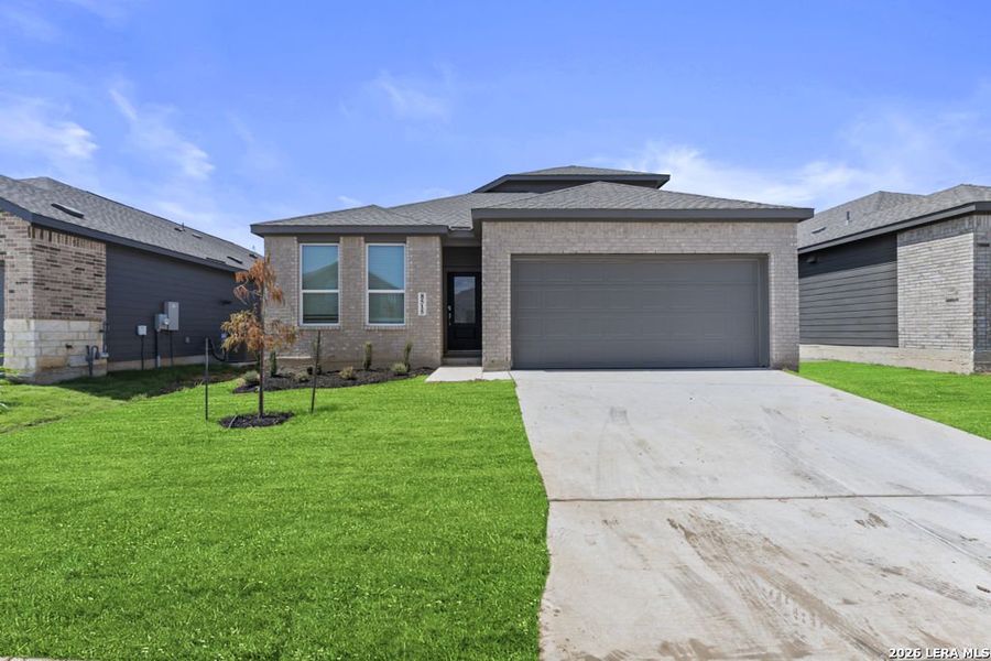 Front exterior of a new home in Grace Gardens, San Antonio, TX, highlighting curb appeal (Image 1). Front exterior of a new home in Grace Gardens, San Antonio, TX, highlighting curb appeal (Image 1).