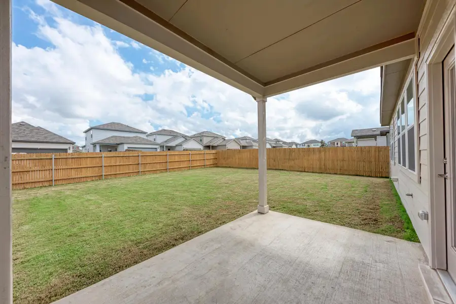 A spacious backyard with a private fence, perfect for outdoor activities.