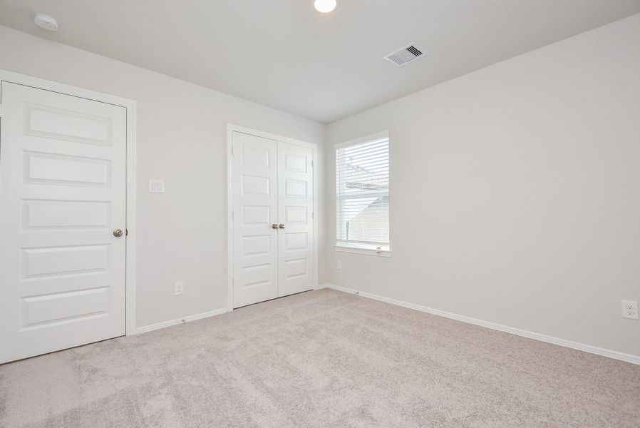 'Looks like great closet space in this carpeted secondary bedroom with its large corner window, adding more wall and floor space! 'Looks like great closet space in this carpeted secondary bedroom with its large corner window, adding more wall and floor space!