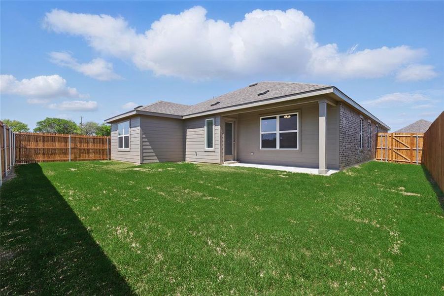 Back of property featuring a patio, a fenced backyard, brick siding, and a shingled roof