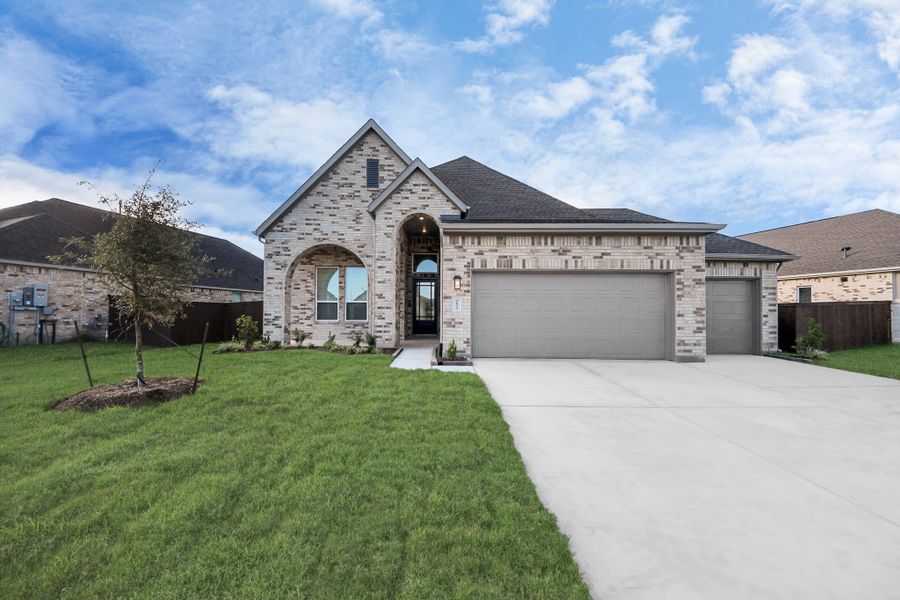 Front exterior of a new home in Meridiana, Manvel, TX, highlighting curb appeal (Image 26).
