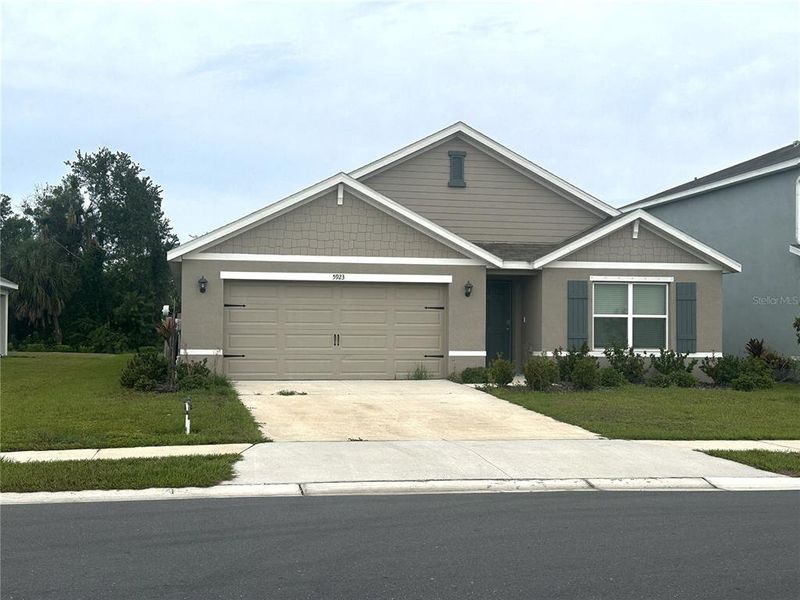 Front exterior of a new home in Silverstone North, Palmetto, FL, highlighting curb appeal (Image 25).