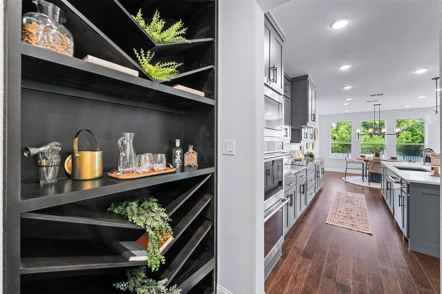 Kitchen with gray cabinets, dark wood-style floors, light countertops, pendant lighting, and recessed lighting