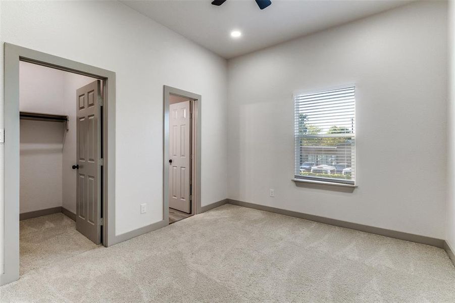Unfurnished bedroom with light carpet, a walk in closet, recessed lighting, and ceiling fan Unfurnished bedroom with light carpet, a walk in closet, recessed lighting, and ceiling fan