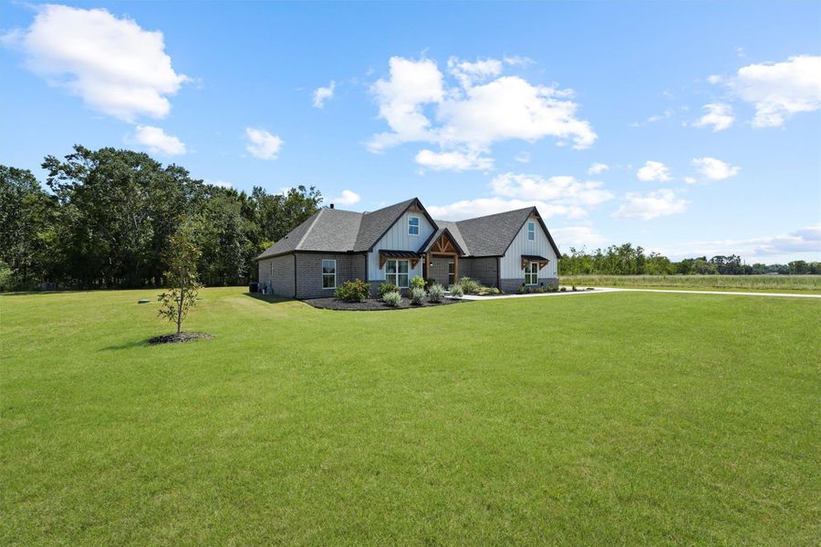 Front exterior of a new home in , Dayton, TX, highlighting curb appeal (Image 5).