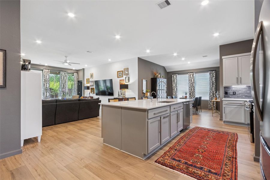 Open concept kitchen dining and living room allows