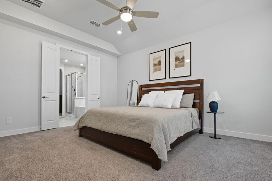 The primary bedroom is an oasis in the home with tray ceiling & serene views out to the backyard.