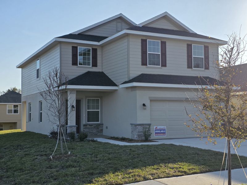 Front exterior of a new home in Arbor Park, Leesburg, FL, highlighting curb appeal (Image 2).