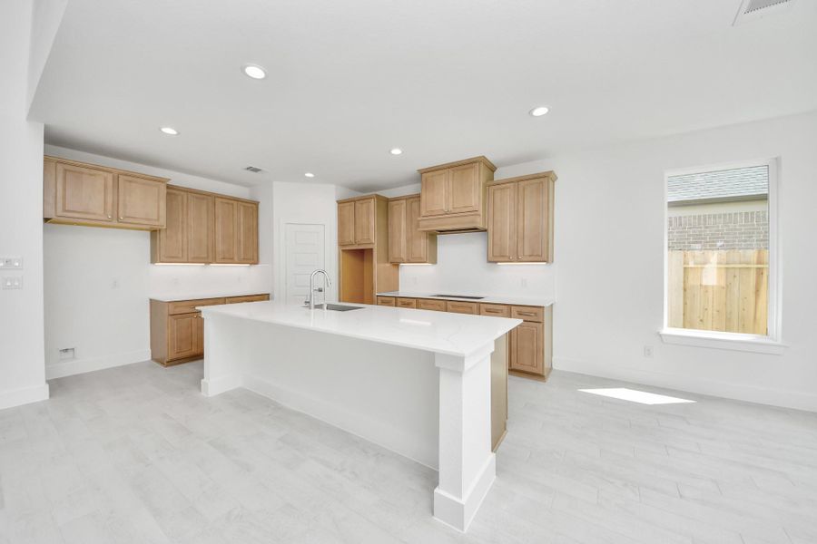 Step into a dream realized with this generously spacious kitchen! A massive granite island takes center stage, complemented by high ceilings and soft-close cabinets. The granite countertops, stainless steel appliances, sleek tile backsplash, and recessed lighting complete the elegant design. Step into a dream realized with this generously spacious kitchen! A massive granite island takes center stage, complemented by high ceilings and soft-close cabinets. The granite countertops, stainless steel appliances, sleek tile backsplash, and recessed lighting complete the elegant design.