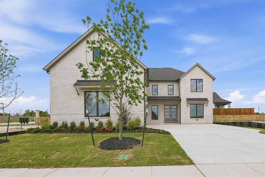 Front exterior of a new home in Custer Ridge Estates, Allen, TX, highlighting curb appeal (Image 24). Front exterior of a new home in Custer Ridge Estates, Allen, TX, highlighting curb appeal (Image 24).