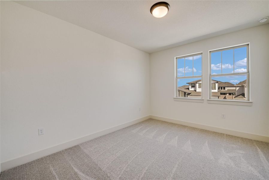 Carpeted empty room with baseboards