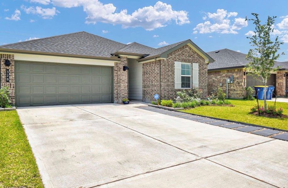 Front exterior of a new home in Riverwood Ranch, Angleton, TX, highlighting curb appeal (Image 21).