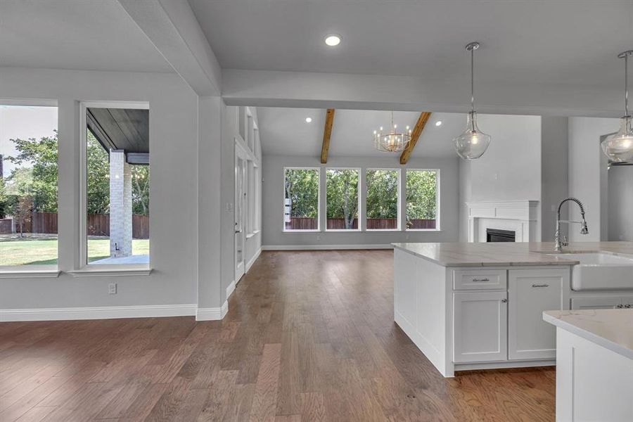 Kitchen featuring hanging light fixtures, plenty of natural light, and sink