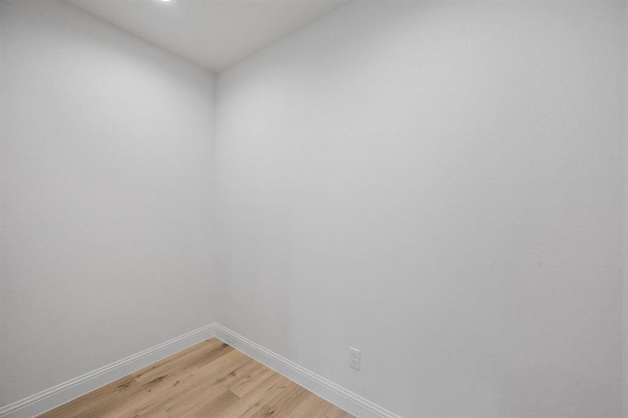 Spare room with light wood-style flooring and baseboards