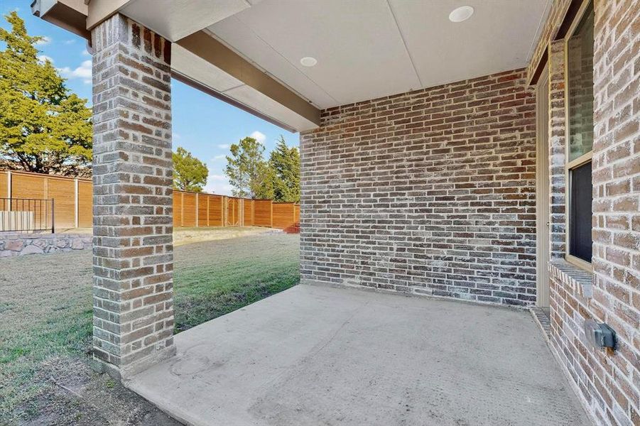 Fenced backyard featuring a patio area Fenced backyard featuring a patio area