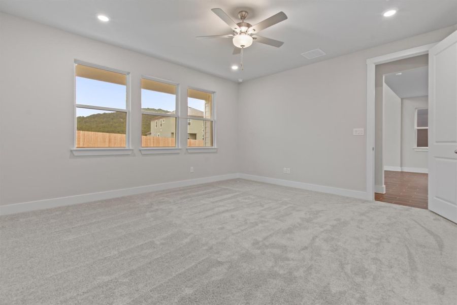 Spare room with ceiling fan and carpet floors