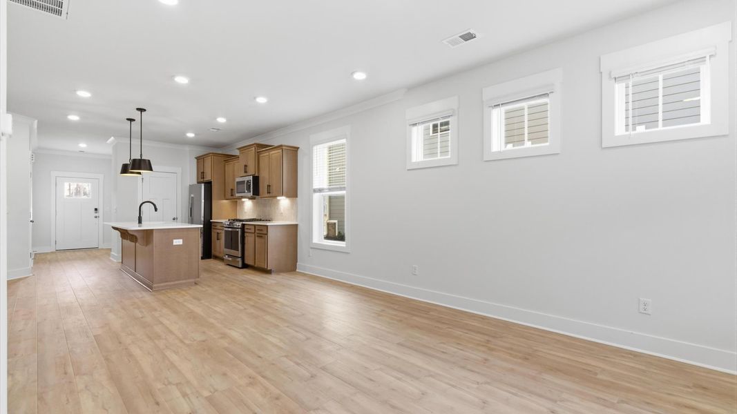 Memorable moments begin in this elegant, open family room with hardwood flooring and refined finishes