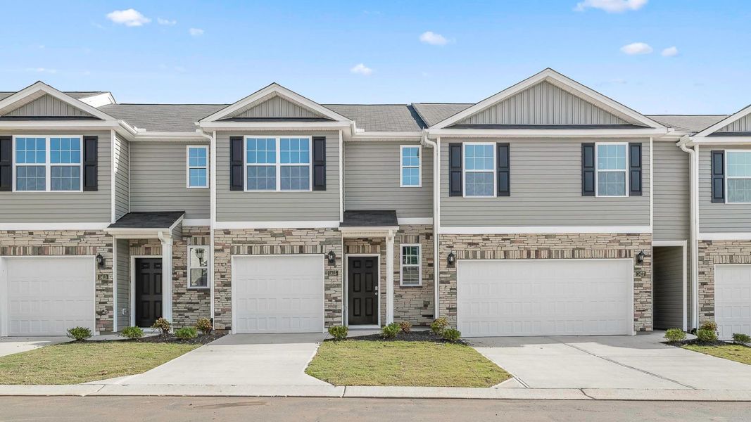 Front exterior of a new home in North Village Townes, Greensboro, NC, highlighting curb appeal (Image 1). Front exterior of a new home in North Village Townes, Greensboro, NC, highlighting curb appeal (Image 1).