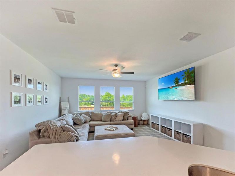 Living area featuring carpet floors and ceiling fan