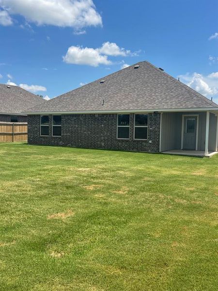 Back of property with a patio area and a lawn