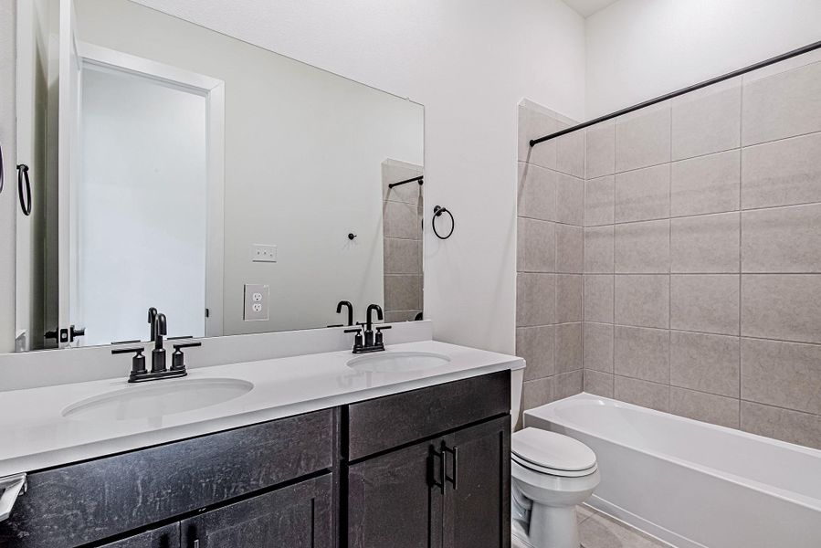 The secondary bathroom is finished with modern fixtures and a clean, timeless design The secondary bathroom is finished with modern fixtures and a clean, timeless design
