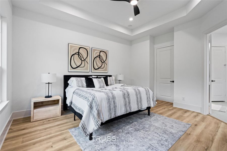 Ceiling height and symmetry define the primary suite, where simplicity and sophistication meet.